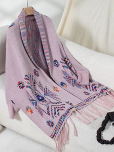 Detail of purple Aztec knit cardigan with colorful geometric patterns and long fringe