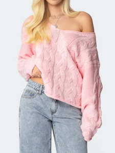 Pink V-neck cable knit oversized sweater for women paired with high-waisted blue jeans