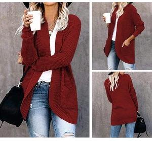 Detailed view of wine red knit cardigan featuring side pockets and curved open hemline