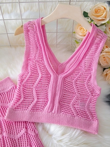 Pink crochet hollow knit set with V-neck camisole and shorts on a hanger for beachwear