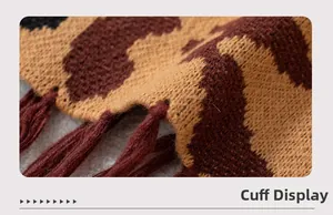 Close-up of leopard print knit poncho cuff with long tassel details and soft texture
