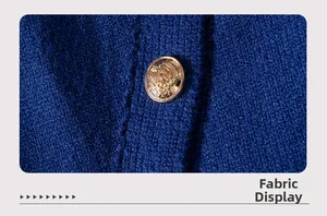Macro detail of navy blue knit fabric featuring a vintage gold crest button