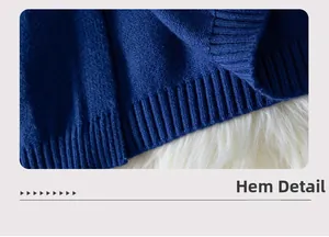 Close-up of navy blue knit sweater hem featuring high-quality ribbed texture and elastic finish
