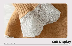 Detail view of camel knit sweater cuff with intricate white lace patchwork trim