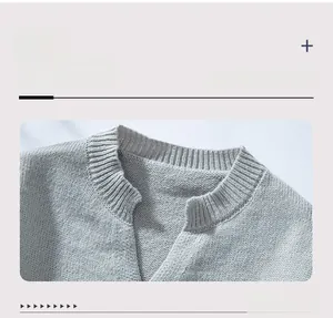Detail view of the V-neckline with ribbed edging on a casual grey knitted sweater