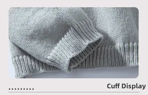 Detailed macro view of the ribbed knit cuffs and hem on this light grey pullover sweater