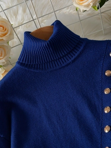 Elegant navy blue turtleneck sweater with side gold buttons and fine knit texture