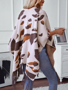 Women's leopard print knit poncho wrap with fringes and animal pattern details
