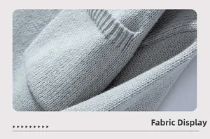 Close-up of light grey knit fabric texture with soft folds and detailed plain stitching