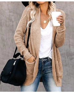 Close-up of chunky knit khaki cardigan showing large pocket and soft texture detail