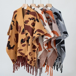 Detail of leopard print knitted ponchos in multiple colors with stylish tassel fringes