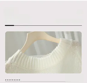 Close-up of ribbed crew neck on off-white knitted sweater showing fine texture