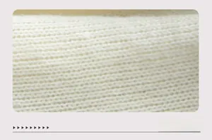 Close-up of premium white knit fabric showing thick texture and soft weave detail