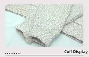 Close-up of the thick knitted cuff detail showing the warm beige blended fabric texture