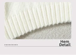 Close-up detail of the ribbed knit hemline on a white minimalist sweater for women