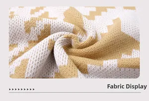 Texture détaillée du tissu à motif zigzag jaune et blanc sur le pull en tricot