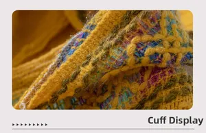 Detailed close-up of knitted cuff featuring ethnic pattern and ginger yellow fibers