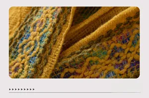 Macro view of ethnic pattern jacquard knitting and thick texture on a yellow wool shawl