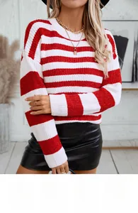 Detail of red and white striped knit sweater with soft chenille texture and crew neck
