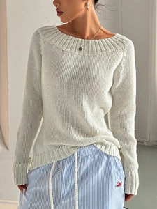 White long-sleeved chunky knit sweater paired with striped drawstring casual trousers