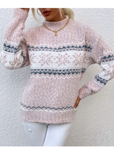 Detail of soft pink Fair Isle knit sweater with white snowflake patterns and mock neck
