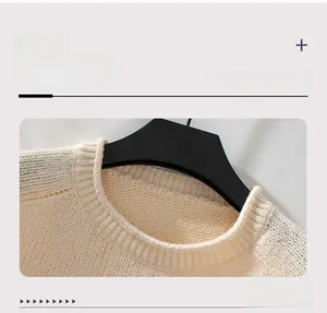 Close-up of the ribbed crew neck on a cream knitted Christmas tree sweater