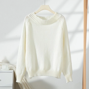 Detailed close-up of vertical ribbed texture on white knitted off-shoulder sweater