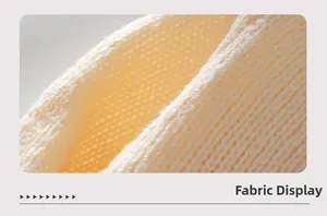 Detailed macro view of the cream knit fabric showing soft texture and premium weave