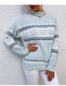 Detailed knit texture of light blue snowflake sweater with festive Fair Isle pattern