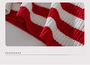 Detailed view of the red and white striped hem on soft chenille knit sweater fabric