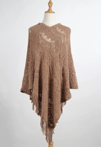 Detail of coffee hollow-out crochet knit poncho with stylish long fringe tassels
