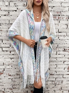 White knitted hooded poncho with colorful geometric patterns and fringe tassels for women