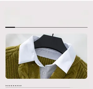 Detailansicht des Hemdkragens am grünen Grobstrickpullover im Lagenlook-Design