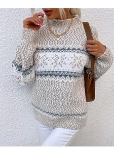 Detail of knitted snowflake pattern and texture on a beige turtleneck Christmas sweater