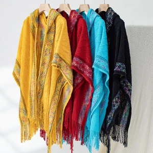 Detail of knit ponchos showing tassel fringe and colorful ethnic jacquard patterns