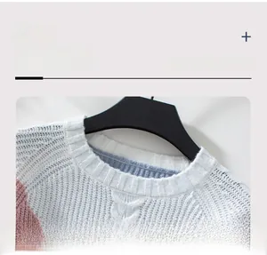 Detail of the crew neckline on a color-block knit sweater with fine stitching