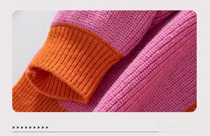 Close-up of pink and orange color-block knit sweater cuffs with ribbed texture details