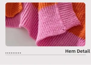 Macro view of the ribbed knit hem on a pink and orange striped cardigan sweater