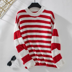 Detailed view of red and white striped chenille sweater texture with ribbed cuffs