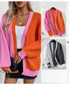 Detail of color block knit cardigan featuring ribbed cuffs and chunky texture in vibrant tones