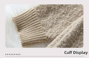 Close-up detail of ribbed cuffs and textured bouclé wool on a cozy knit cardigan