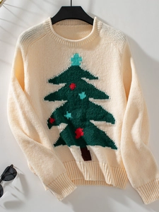 Detail of knitted cream Christmas sweater showing the ribbed cuffs and tree pattern