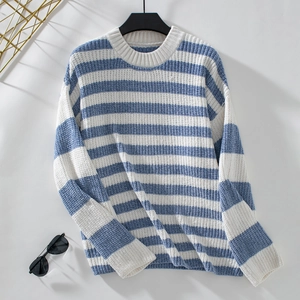 Close-up of blue and white striped chenille knit sweater with ribbed cuffs and crew neck