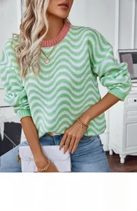 Detail of green and white chevron knit sweater with pink crew neck and drop shoulder