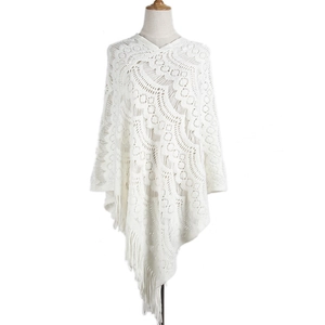 White crochet knit poncho with geometric wave patterns and bohemian tassel details