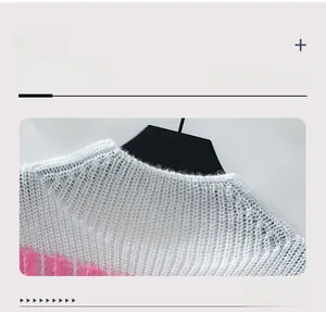 Close-up of knit sweater neckline featuring white and pink striped crochet design