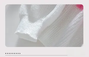 Detailed macro view of white chunky knit sweater cuff with ribbed edge and pink trim