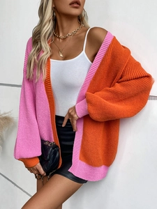 Pink and orange color block knit cardigan with loose fit and ribbed texture