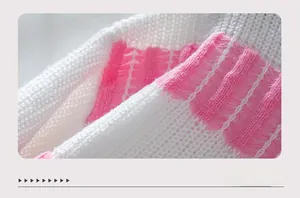 Detailed macro shot of soft pink and white striped knit fabric with textured openwork