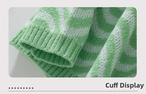 Detailed view of green and white chevron knit pattern with ribbed cuff texture